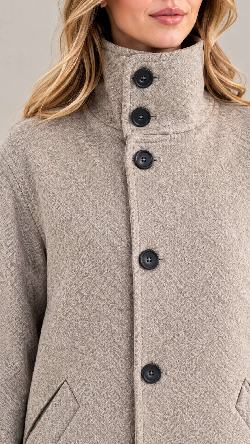 Close-up detail of textured fabric, button closure, and high stand collar on heather grey coat