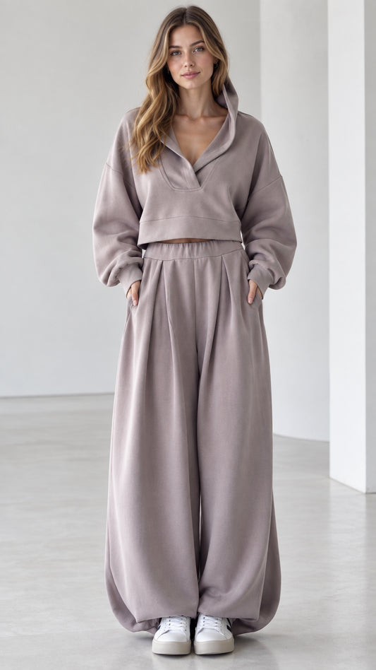 Front view of woman wearing mauve cropped V-neck hoodie and wide-leg pleated sweatpants lounge set