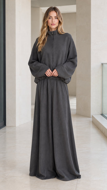 Front full view of woman wearing charcoal grey zip-up mock neck jacket and wide-leg lounge pants set