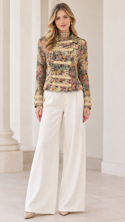 Full front view of model wearing Multi Floral tapestry military jacket with white wide-leg trousers