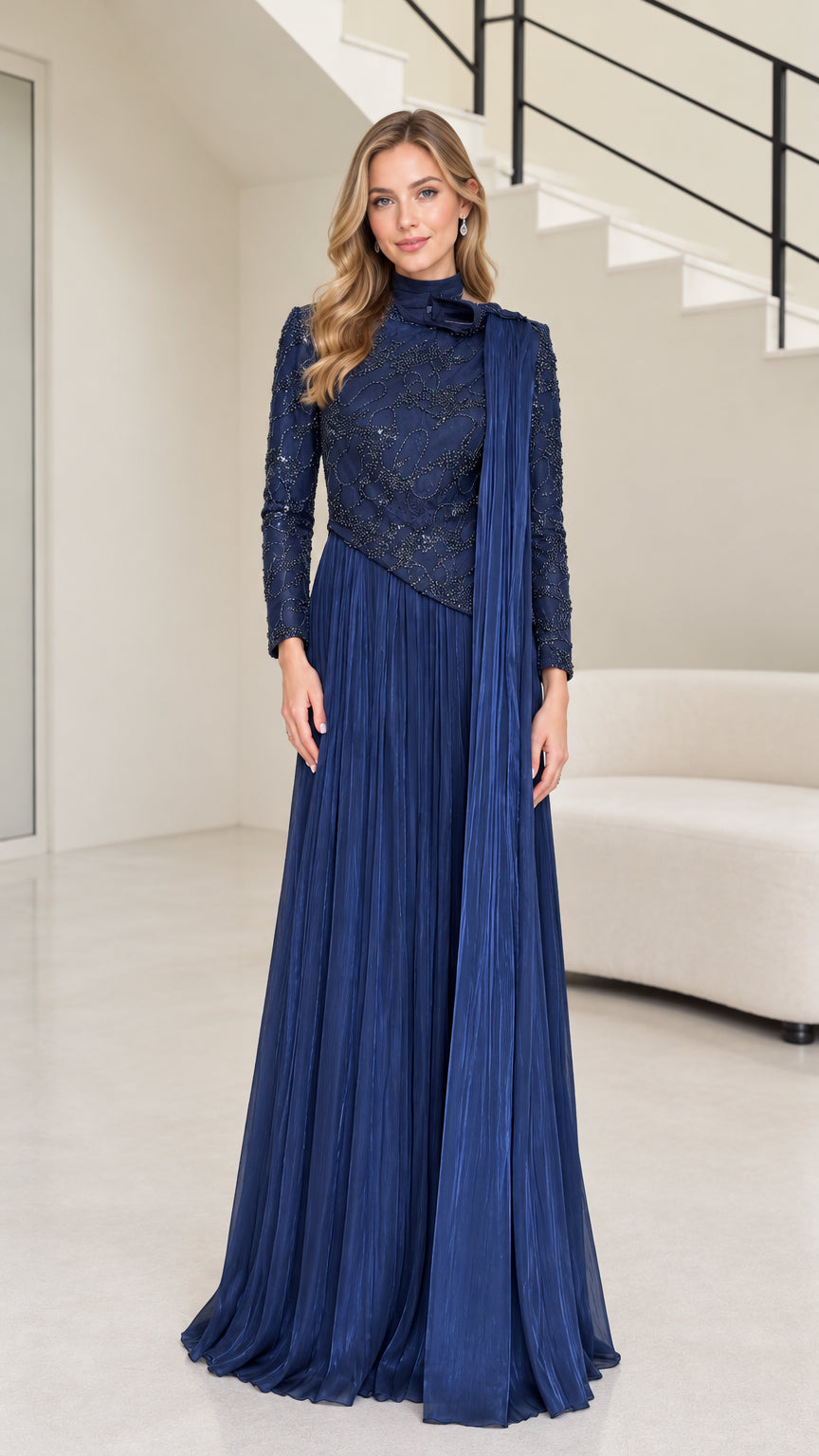 Front full-length view of navy blue long sleeve beaded evening maxi gown with pleated skirt and shoulder drape