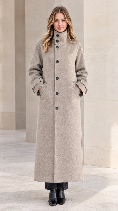 Front full view of woman wearing heather grey high stand collar maxi coat with black boots