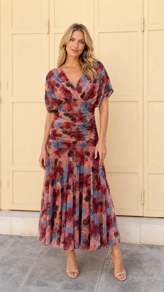 Front full view of woman wearing multi pink floral ruched midi dress