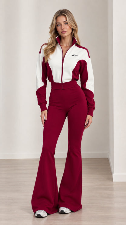 Front full-length view of woman wearing burgundy and white colorblock flare jumpsuit