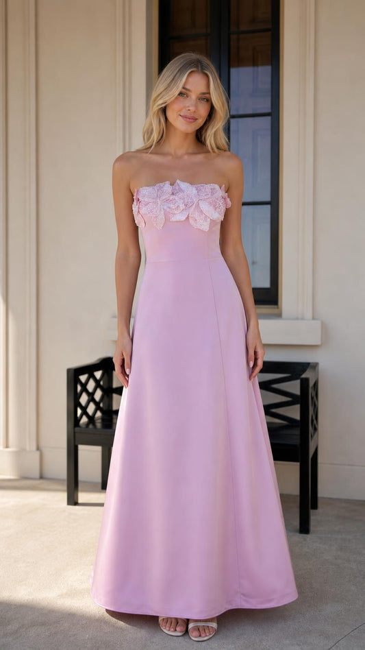 Front view of model wearing pink strapless 3D floral maxi dress