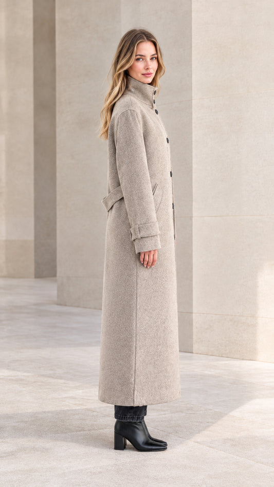 Side profile of woman in heather grey long overcoat showing sleek tailored fit