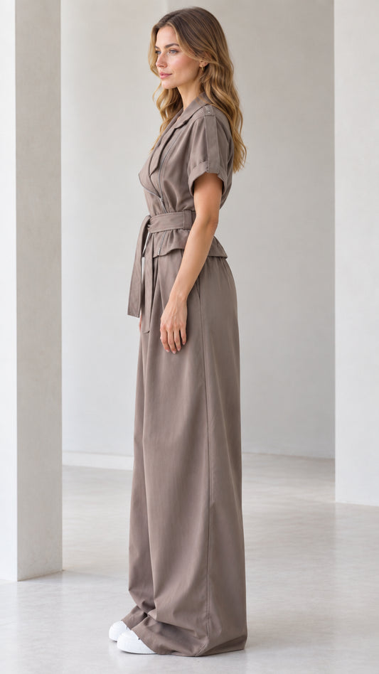 Side profile view of taupe short sleeve wide leg belted jumpsuit