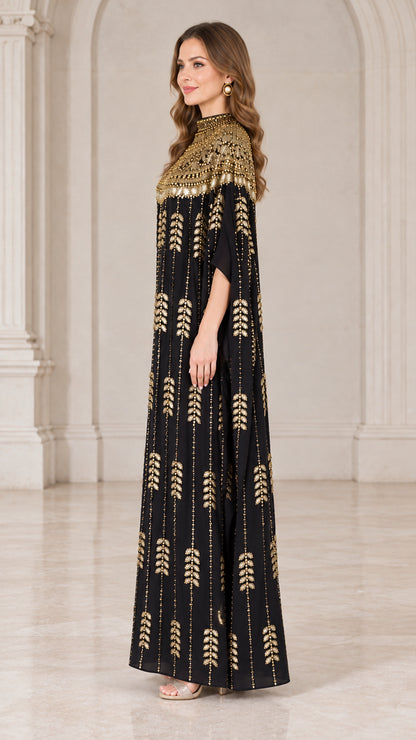 Side angle of black cape sleeve evening kaftan gown with shimmering sequin detailing