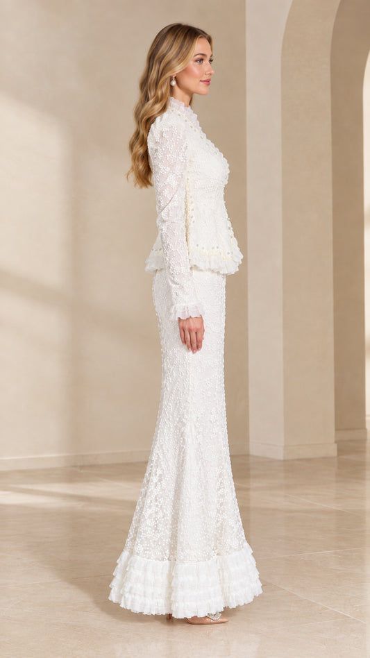 Side view of woman wearing white lace peplum evening set