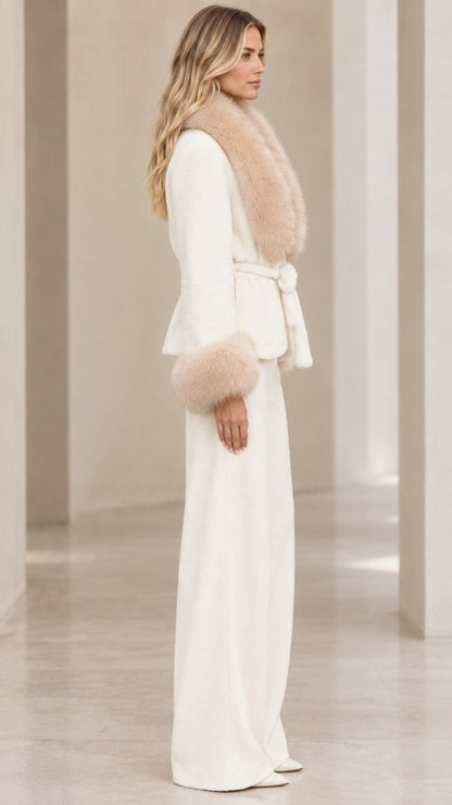 Side profile of woman in cream faux fur trim jacket and matching palazzo pants
