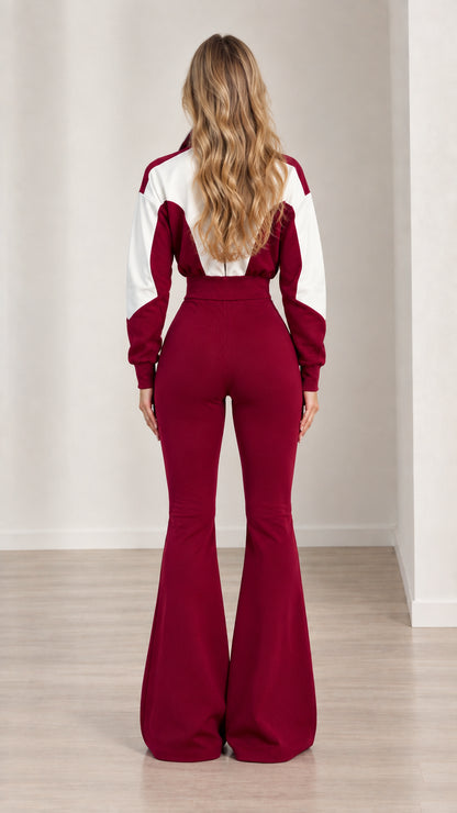 Back full-length view of woman in burgundy colorblock flare jumpsuit