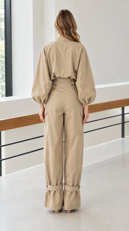 Back view of woman wearing khaki matching blouse and wide-leg pants set