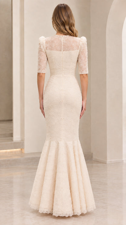 Back view of model in cream illusion lace back mermaid formal dress