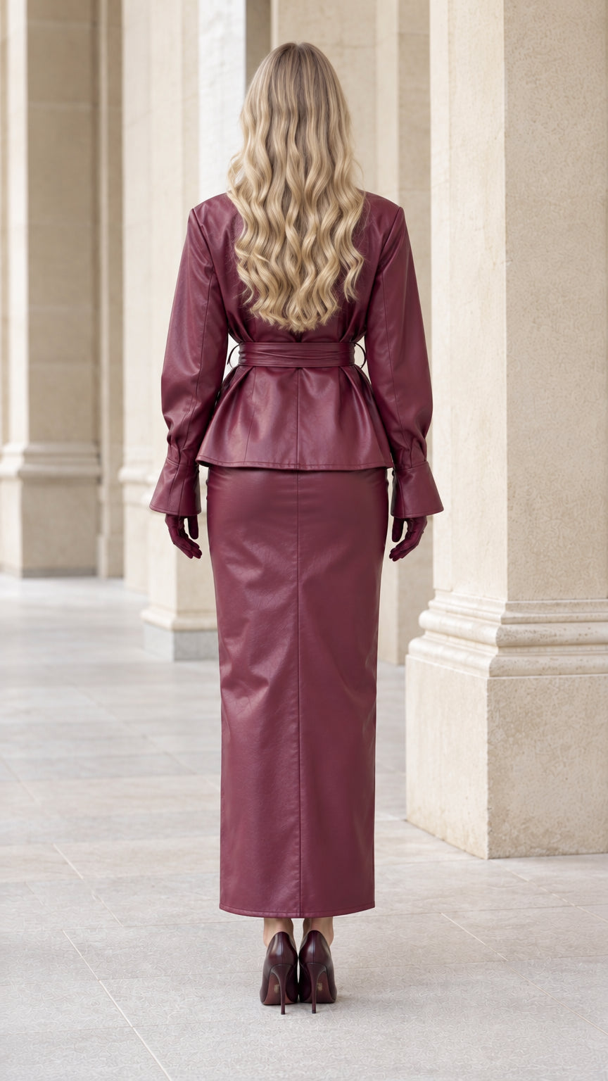 Back view of model wearing Burgundy faux leather belted jacket and straight maxi skirt