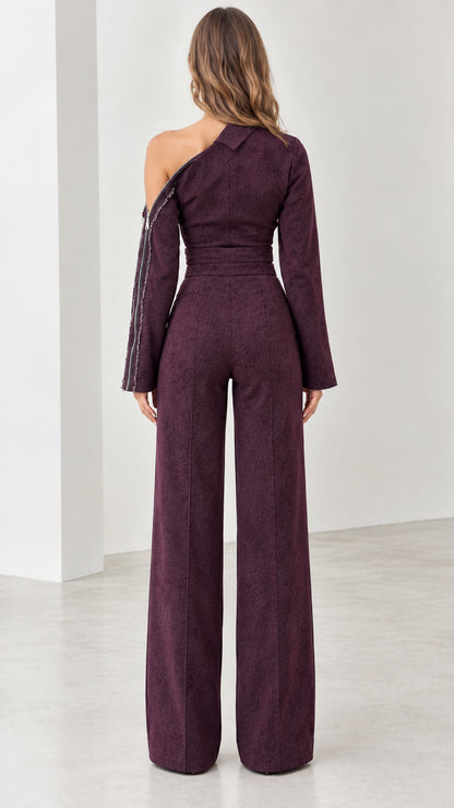 Back view of model showcasing tailored fit of plum one-shoulder jumpsuit