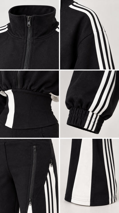 Close-up details of stand collar, zipper pockets, cuffs, and contrast hem on black tracksuit