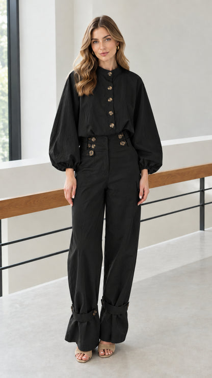 Front view of woman wearing black utility blouse and wide-leg pants set