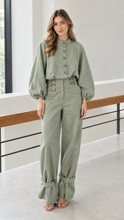Front view of woman wearing sage green button-front blouse and wide-leg pants set