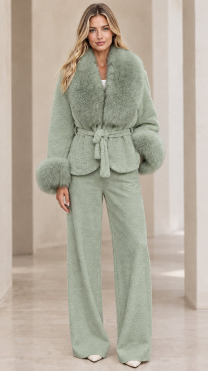 Model wearing sage green belted jacket with faux fur trim and coordinated pants set