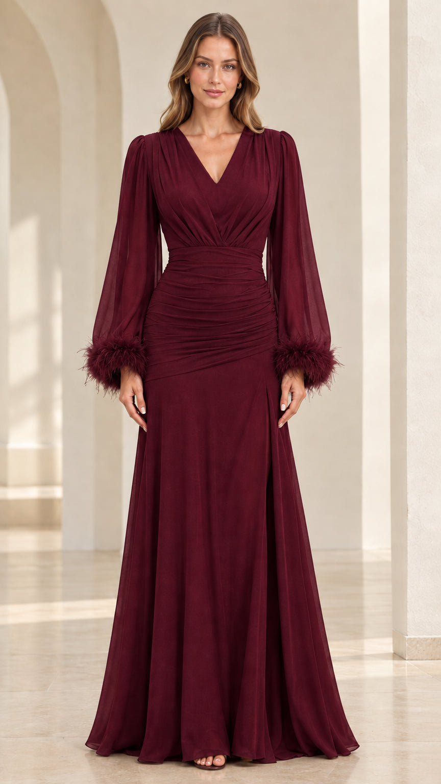 Model wearing burgundy floor-length evening gown with long feather-trimmed sleeves