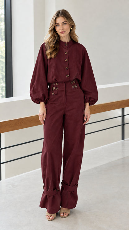 Front view of woman wearing burgundy two-piece utility blouse and pants set